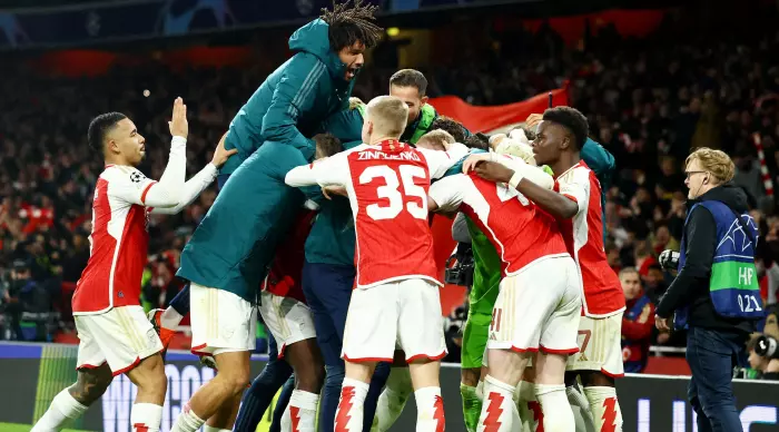 Arsenal players celebrate qualifying for the quarter-finals (Reuters)