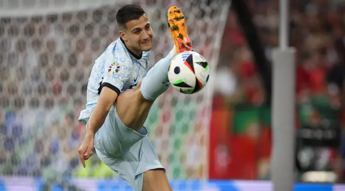 Diogo Dalot stretches his leg towards the ball (Radad Jabara)