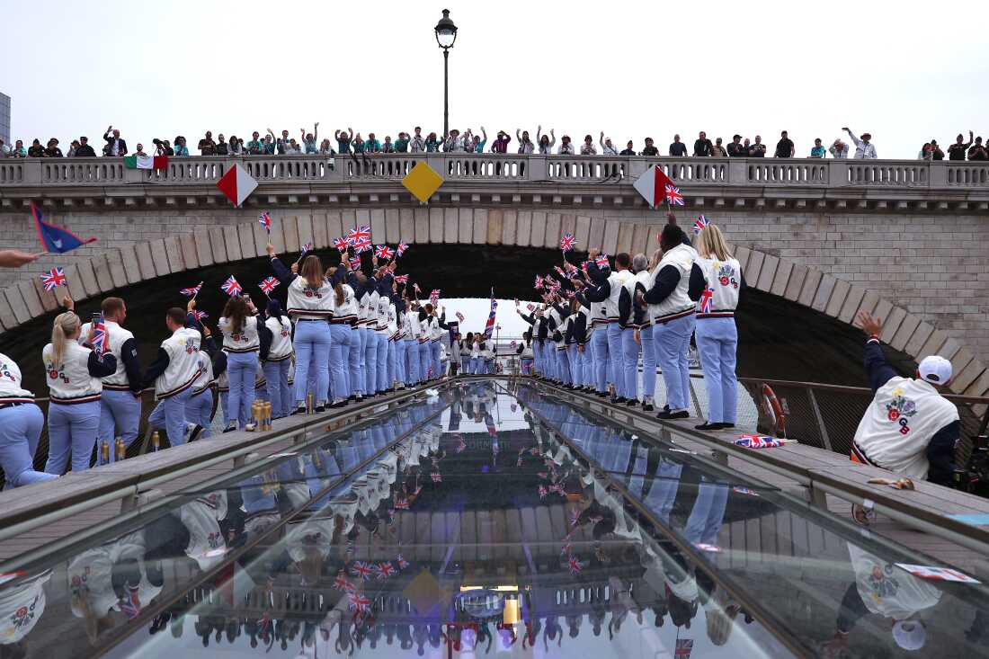 Spectators cheer as Athletes of Team Great Britain pass under a bridge during the opening ceremony of the Olympic Games Paris 2024 on July 26.