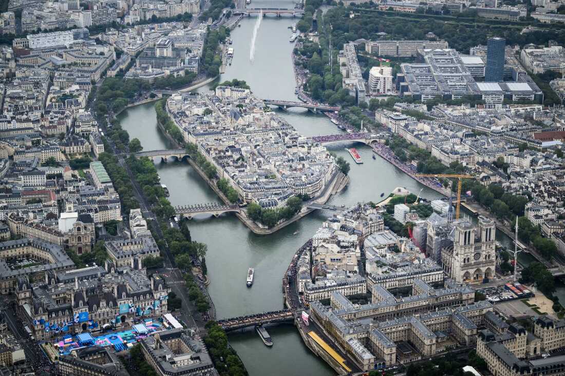 In this aerial view taken from helicopter shows Notre-Dame de Paris Cathedral as delegations boats navigate on the Seine past the Ile de la Cite Island during the opening ceremony of the Olympic Games Paris 2024 on July 26.