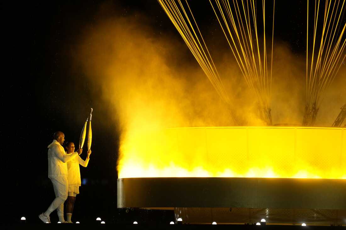 The cauldron is lit by torch bearers Marie-Jose Perec and Teddy Riner in Paris, France, during the opening ceremony of the 2024 Summer Olympics, Friday, July 26.