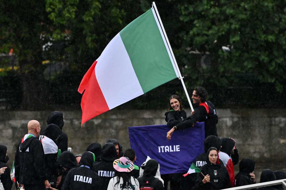 Italy athletes aboard a boat in the floating parade on the river Seine during the Opening Ceremony of the Olympic Games Paris 2024 on July 26.