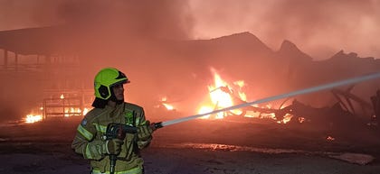 Fire crews at the fire that broke out in the springs following the firing of the rockets, yesterday