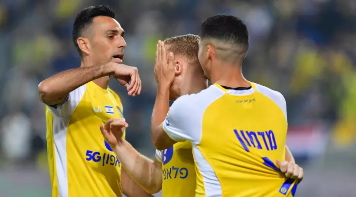 Elad Madmon and Eran Zahavi celebrate with Ido Shahar (Michael holidays)